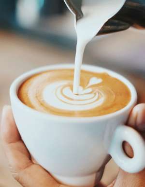 Coffee being poured with latte art