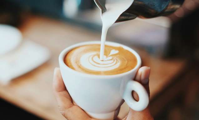Coffee being poured with latte art