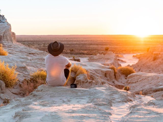 Man watching the sunset at the Walls of China in Mungo National Park, Mungo