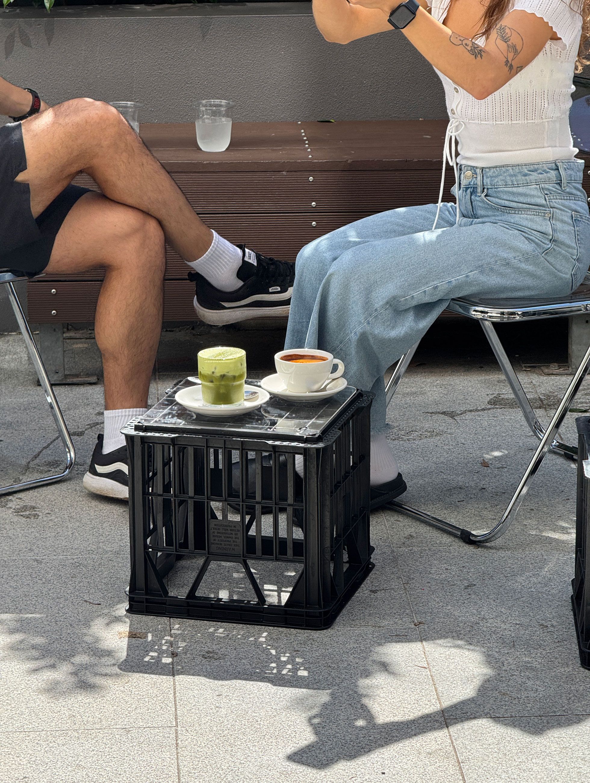 Patrons sit on foldable chairs and dine at Public Supply