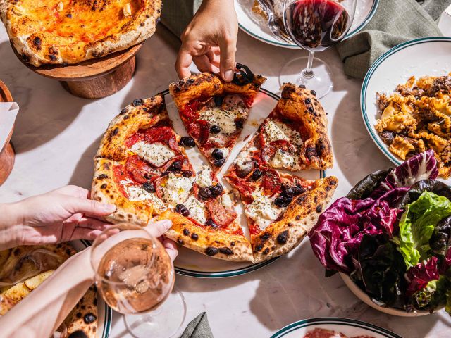 soluna sydney restaurant people eating wood fired pizza and drinking wine