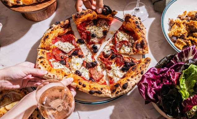 soluna sydney restaurant people eating wood fired pizza and drinking wine