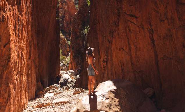 woman walking through Standley Chasm near alice springs