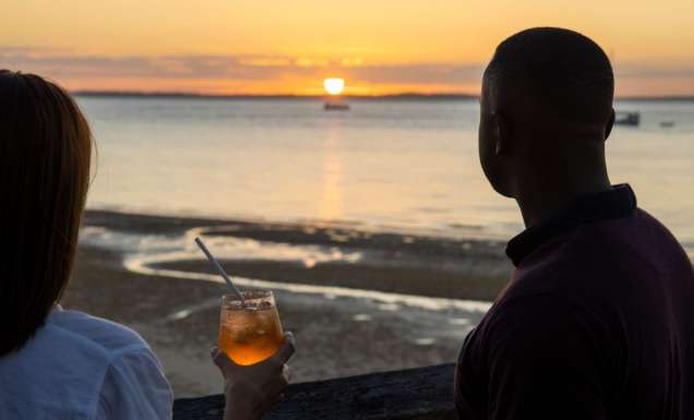 two people drinking cocktails at sunset bar, kingfisher bay resort