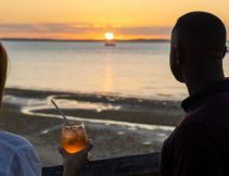 two people drinking cocktails at sunset bar, kingfisher bay resort
