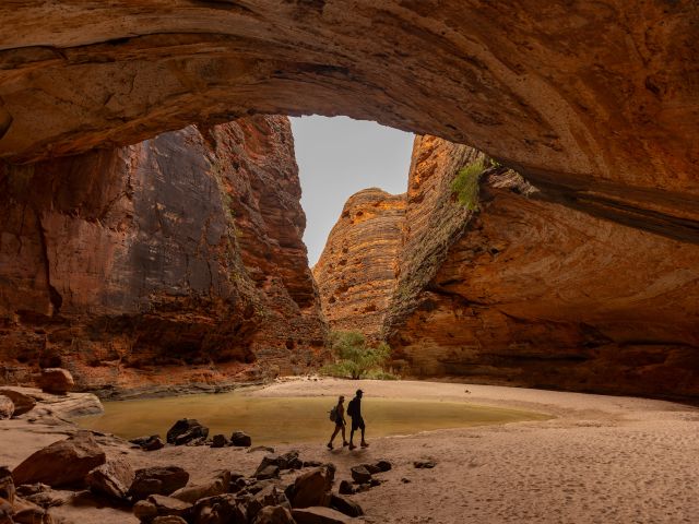 Two people walking around the Bungle Bungle Range is located in the Purnululu National Park.