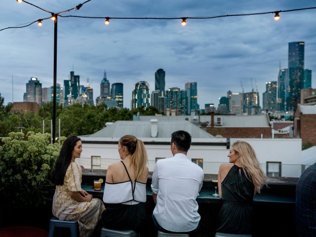 friends dining on the rooftop bar at Johnny’s Green Room