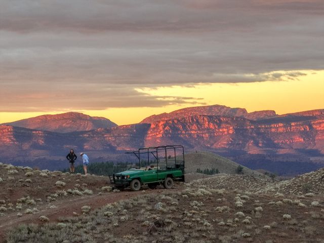 two people standing next to a 4wd in Arkaba