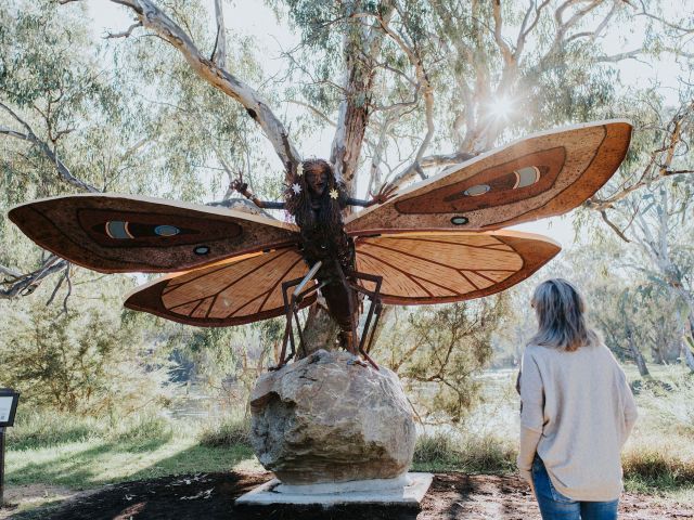 woman looking at sculpture along Crossing Place Trail loop