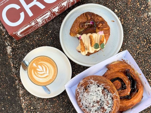 pastries next to a pastry box from crumb cafe in newcastle