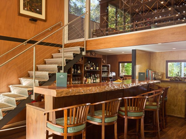 A timber wine cellar and bar with bar stools
