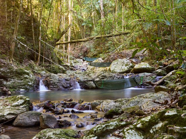 Hammocks hanging over a creek at Crystal Creek Rainforest Retreat