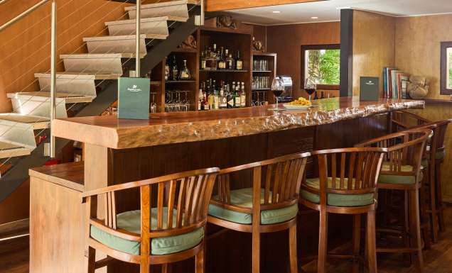 A timber wine cellar and bar with bar stools