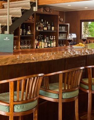 A timber wine cellar and bar with bar stools
