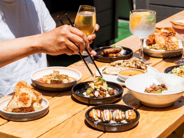 a hand using chopsticks to get food on the table at Baah Lah! Dining, Geelong