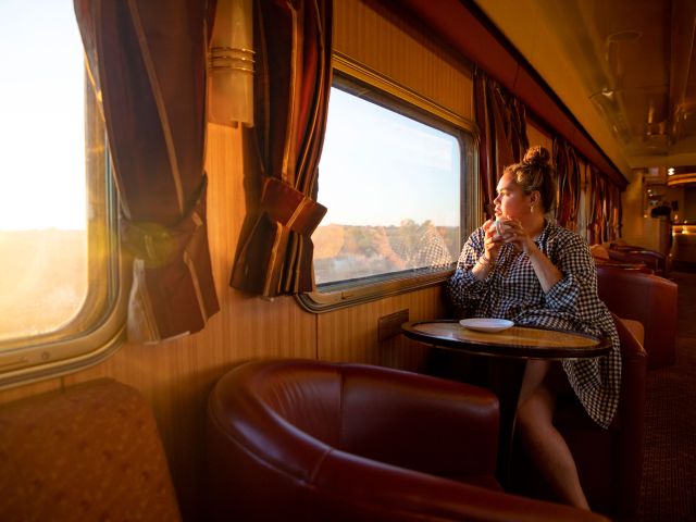 Woman travelling The Ghan in Gold Service Lounge