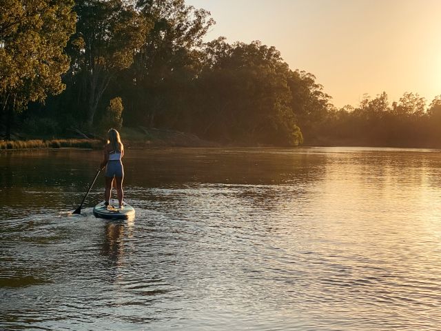 a woman on a stand-up paddle board along the Murray