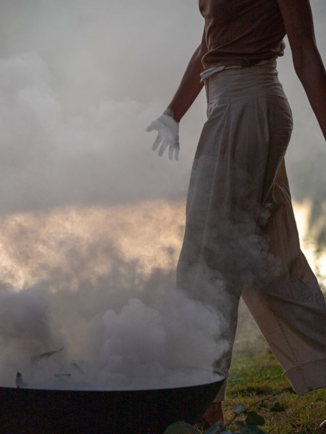 a Nyul Nyul woman conducting a smoke cleansing ceremony