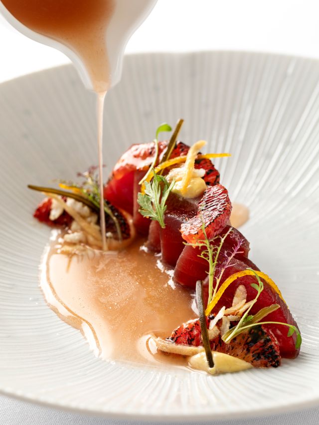 pouring sauce onto a dish at Lake HouseDaylesford