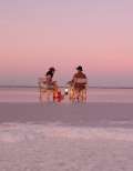 A couple sit on the salt plains of Lake Tyrrell