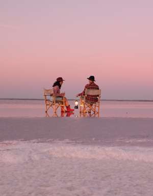 A couple sit on the salt plains of Lake Tyrrell