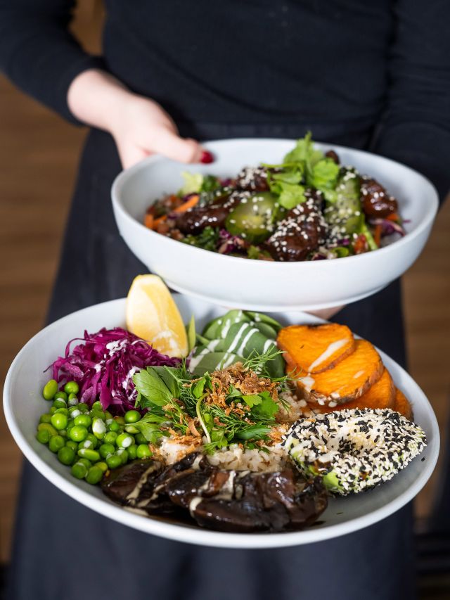 waiter holding two dishes at Riverdeck Cafe albury wodonga