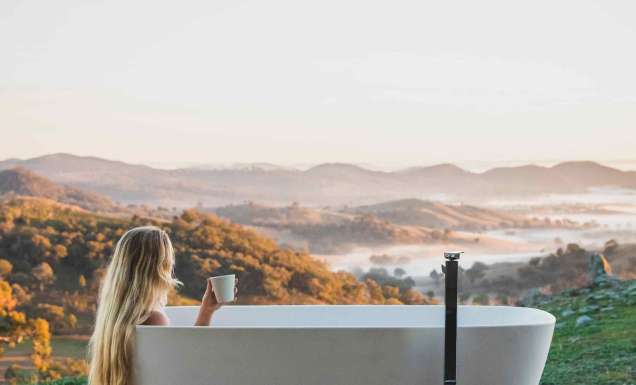 Woman bathes at Sierra Escape with Mudgee views
