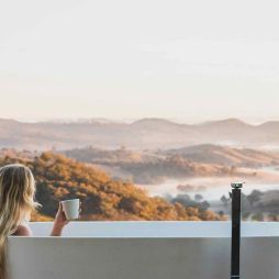 Woman bathes at Sierra Escape with Mudgee views
