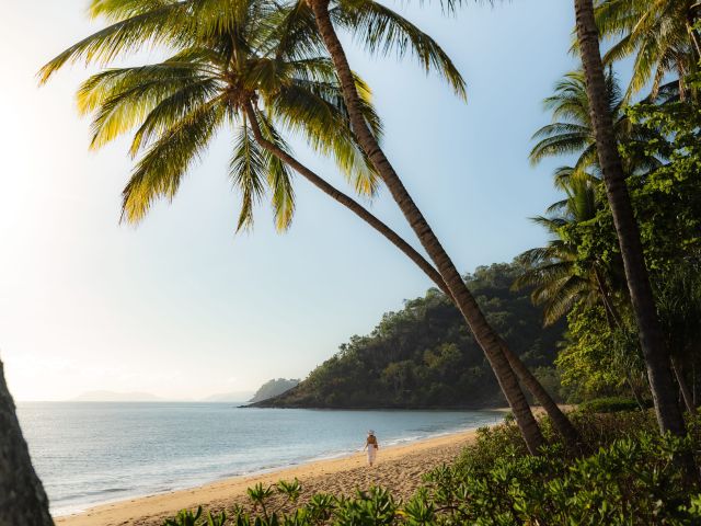 Woman walking on Trinity Beach in Tropical North Queensland