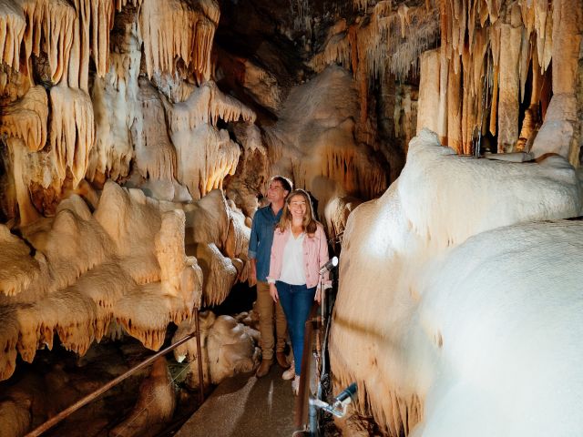 couple walking in cave