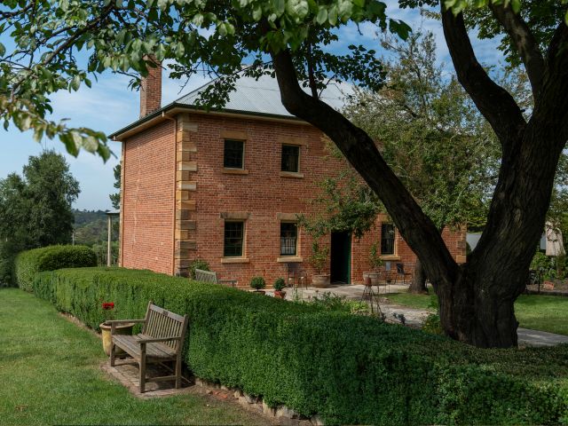 The exterior and manicured gardens of harpers mansion in bowral