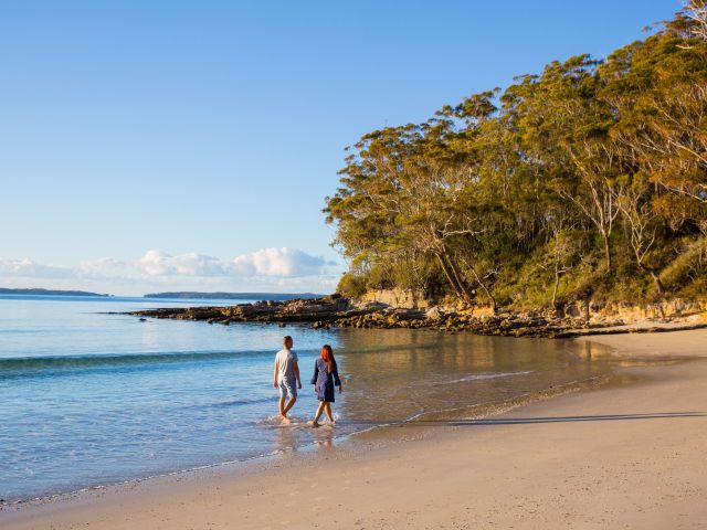 a couple walking along Blenheim Beach, Jervis Bay