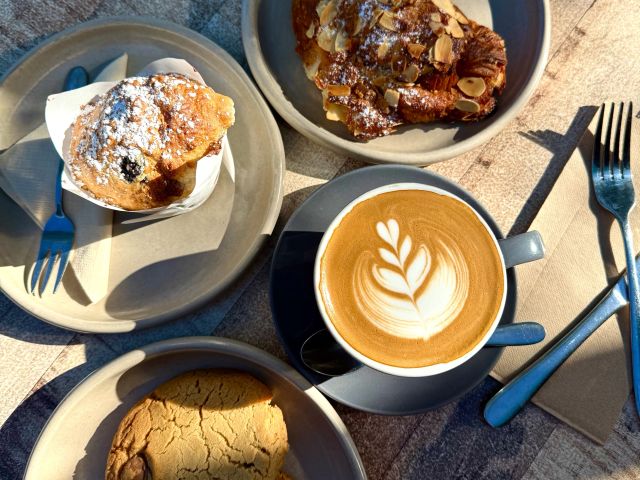 coffee and pastries at <yoastmarkhttps://wp.australiantraveller.com/wp-content/uploads/2025/11/Jervis-Bay-cafes-10.jpg 2600w, https://wp.australiantraveller.com/wp-content/uploads/2025/11/Jervis-Bay-cafes-10.jpg?resize=249,187 249w, https://wp.australiantraveller.com/wp-content/uploads/2025/11/Jervis-Bay-cafes-10.jpg?resize=768,576 768w, https://wp.australiantraveller.com/wp-content/uploads/2025/11/Jervis-Bay-cafes-10.jpg?resize=507,380 507w, https://wp.australiantraveller.com/wp-content/uploads/2025/11/Jervis-Bay-cafes-10.jpg?resize=1536,1152 1536w, https://wp.australiantraveller.com/wp-content/uploads/2025/11/Jervis-Bay-cafes-10.jpg?resize=2048,1536 2048w
