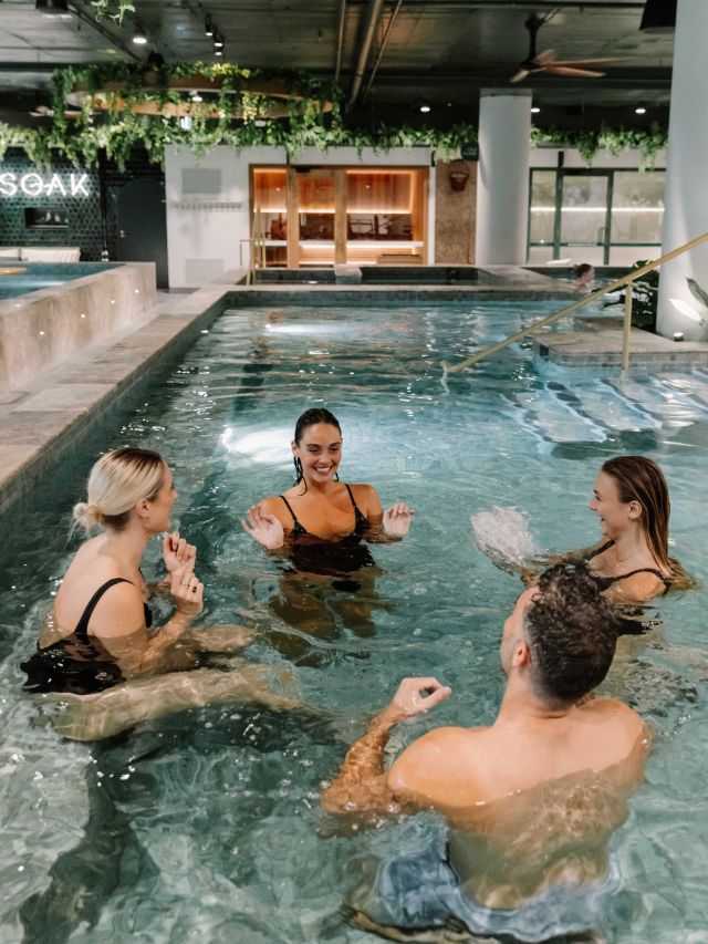 Group of friends in mineral pool at Soak Bathhouse Bondi Junction