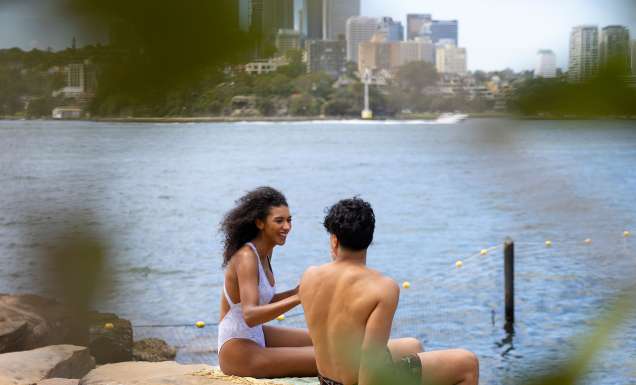 Couple enjoying a swim at Marrinawi Cove in Barangaroo, Sydney swimming spots reopening for summer
