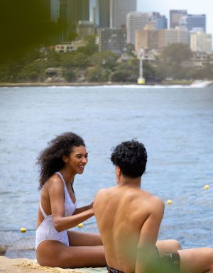 Couple enjoying a swim at Marrinawi Cove in Barangaroo, Sydney swimming spots reopening for summer