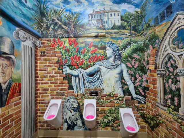 Apollo with his magnifying glass in the male toilets.