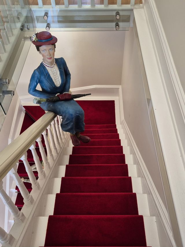 Mary Poppins sliding down the banister in Story Bank