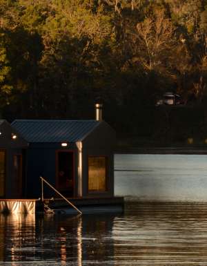 A sauna floating on a lake