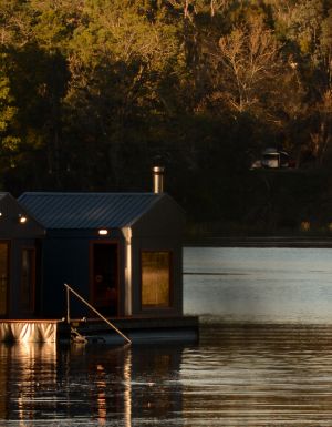 A sauna floating on a lake
