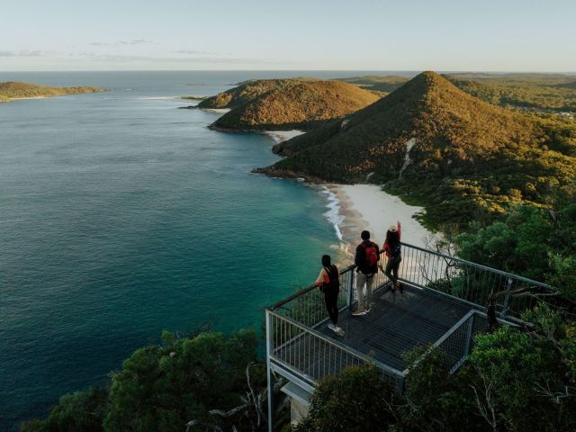 three people standing on the Tomaree Coastal Walk summit