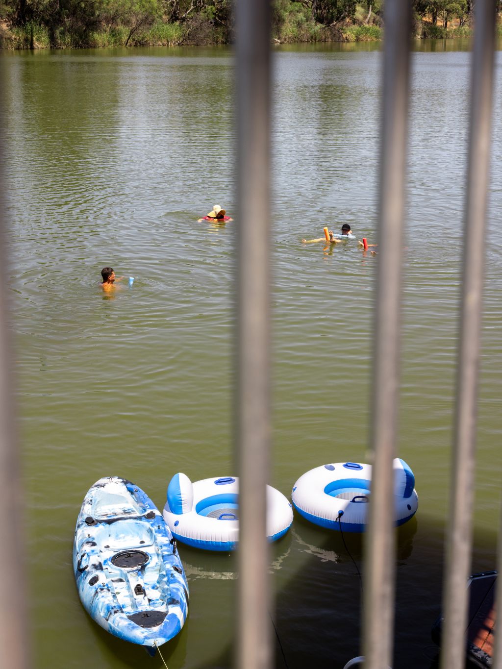 inflatable water tubes and kayaks floating on the Murray River