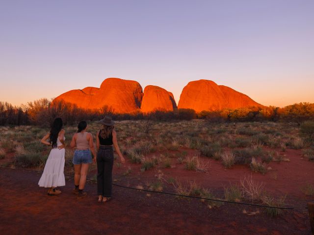 three women looking at Kata Tjuta at sunset