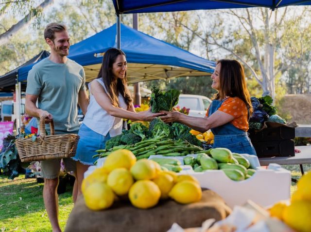 a couple buying veggies at one of the stalls in Echuca Farmers Market