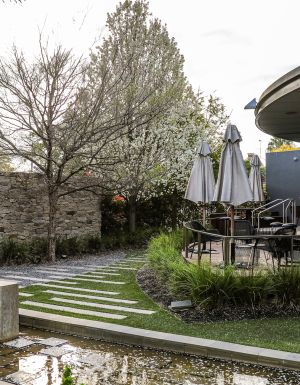 an outdoor seating area surrounded by lush greenery at Junction Moama