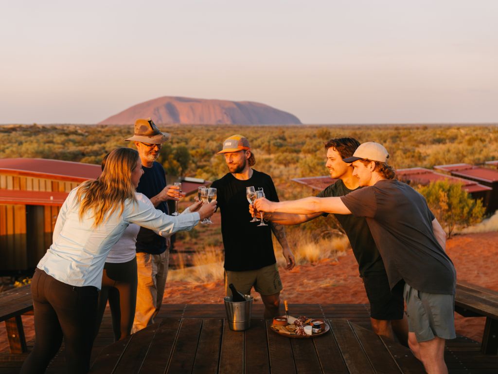 Uluṟu-Kata Tjuṯa Signature Walk group of friends drinking and celebrating