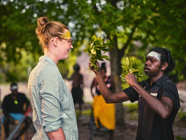 A visitor spends a meaningful moment alongside Yolŋu guides, gaining insight into their deep cultural knowledge and connection to the land.