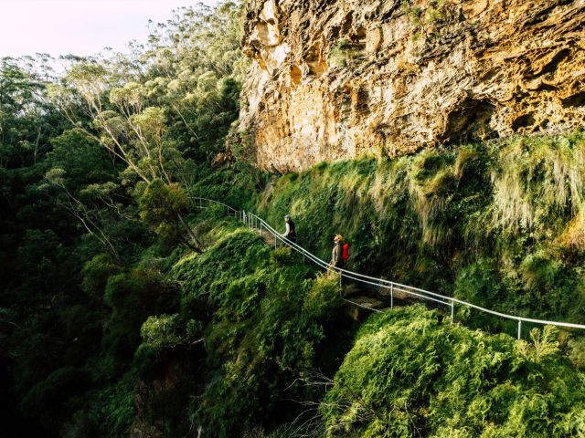 People walking over a bridge along the Grand Cliff Top walk