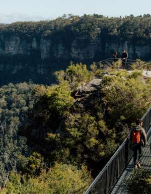 People walking over a bridge along the Grand Cliff Top walk