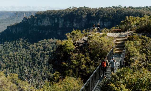 People walking over a bridge along the Grand Cliff Top walk